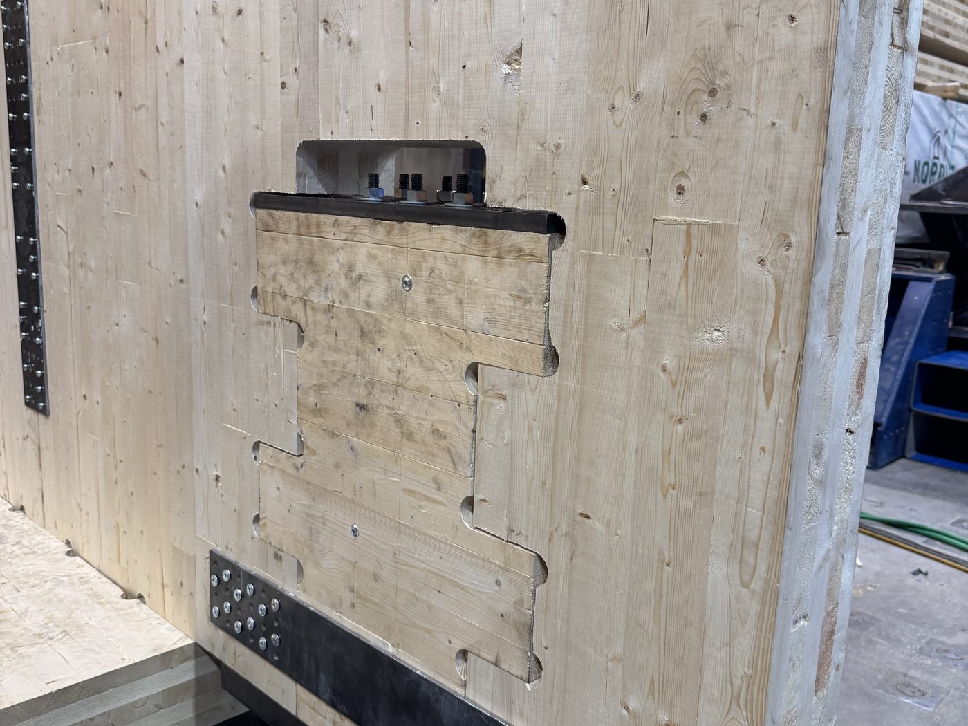 Steel connection hardware at the wall base