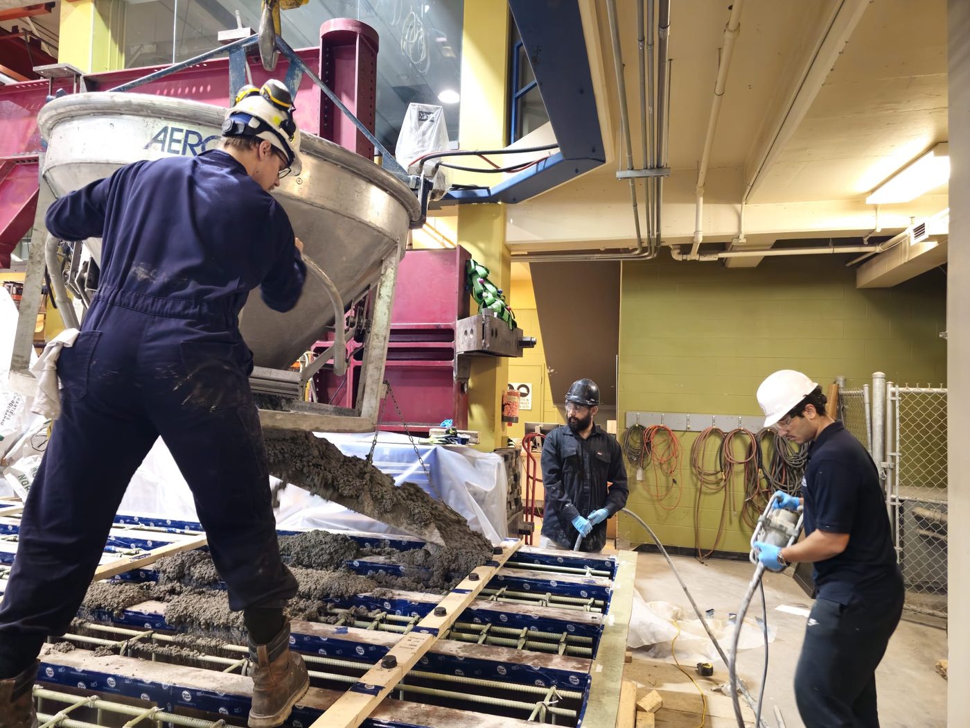 Placing and spreading concrete across the panel form